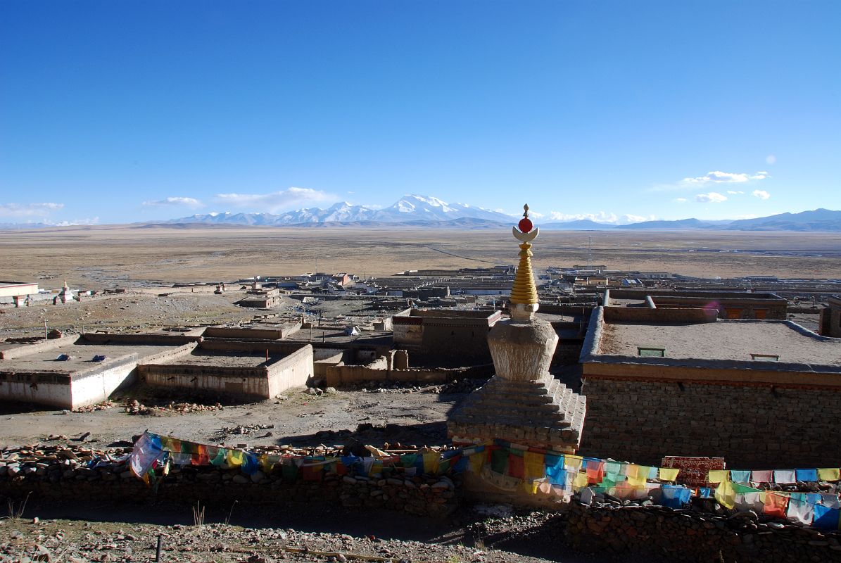 44 Chorten And Mani Wall At North End Of Darchen Village With Barkha Plain Stretching To Gurla Mandhata I climb up above the chorten and mani wall on the northern edge of Darchen for a view of the village and the Barkha Plain stretching to Gurla Mandhata.